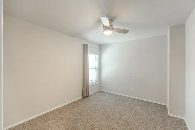 a view of a hallway with closet and bathroom