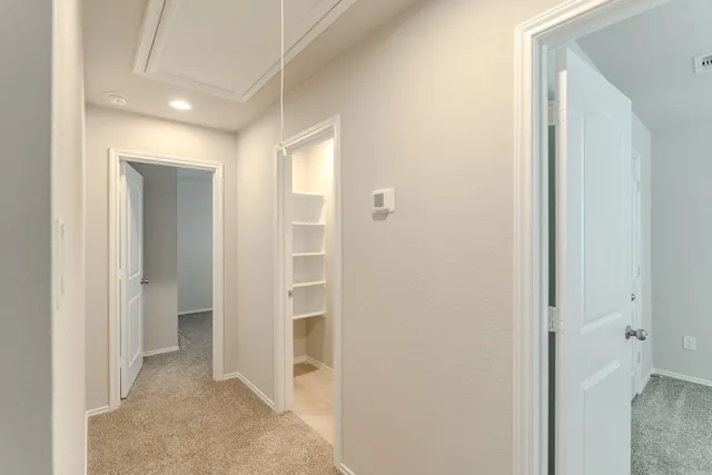 an empty room with a fan and a ceiling fan