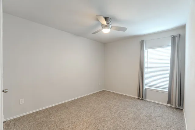 a view of a backyard with wooden fence
