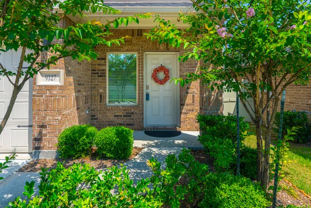 a sign that is sitting in front of a house