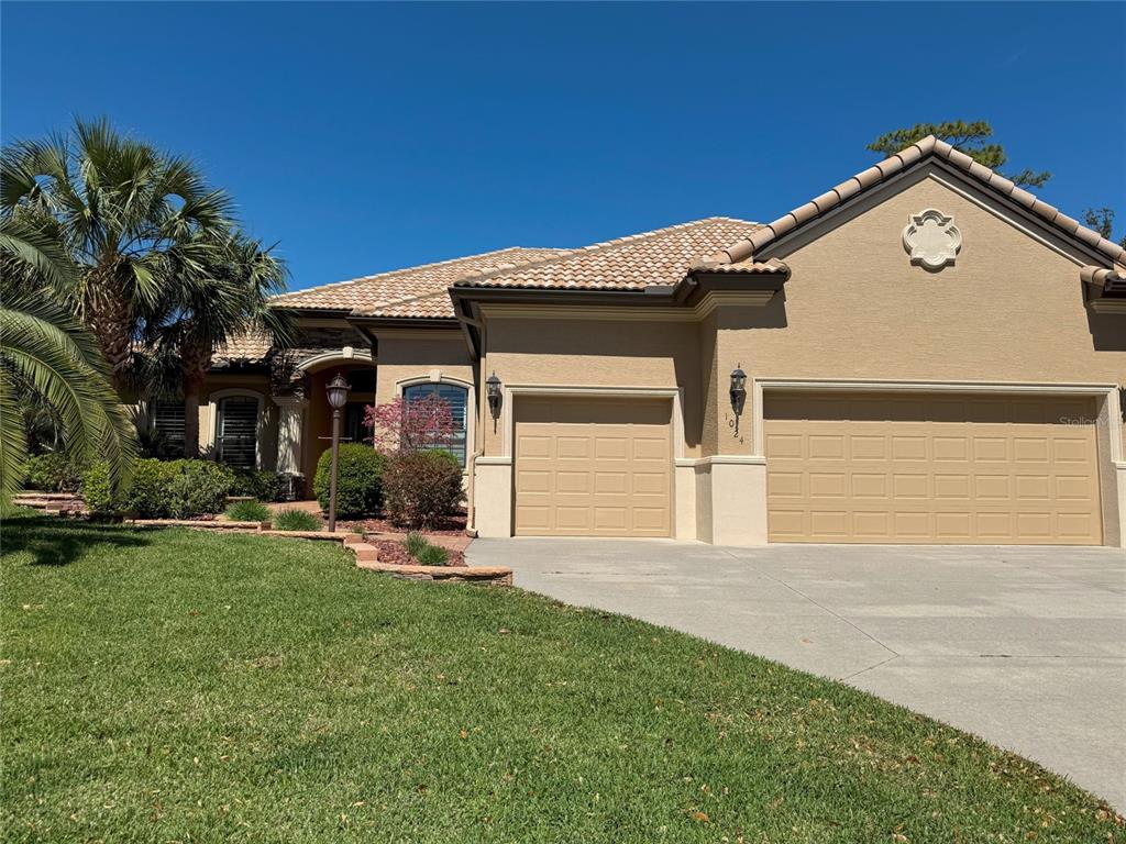 1024 West Beagle Run Loop Hernando, FL 34442 - Photo 44 of 44 a front view of a house with a yard