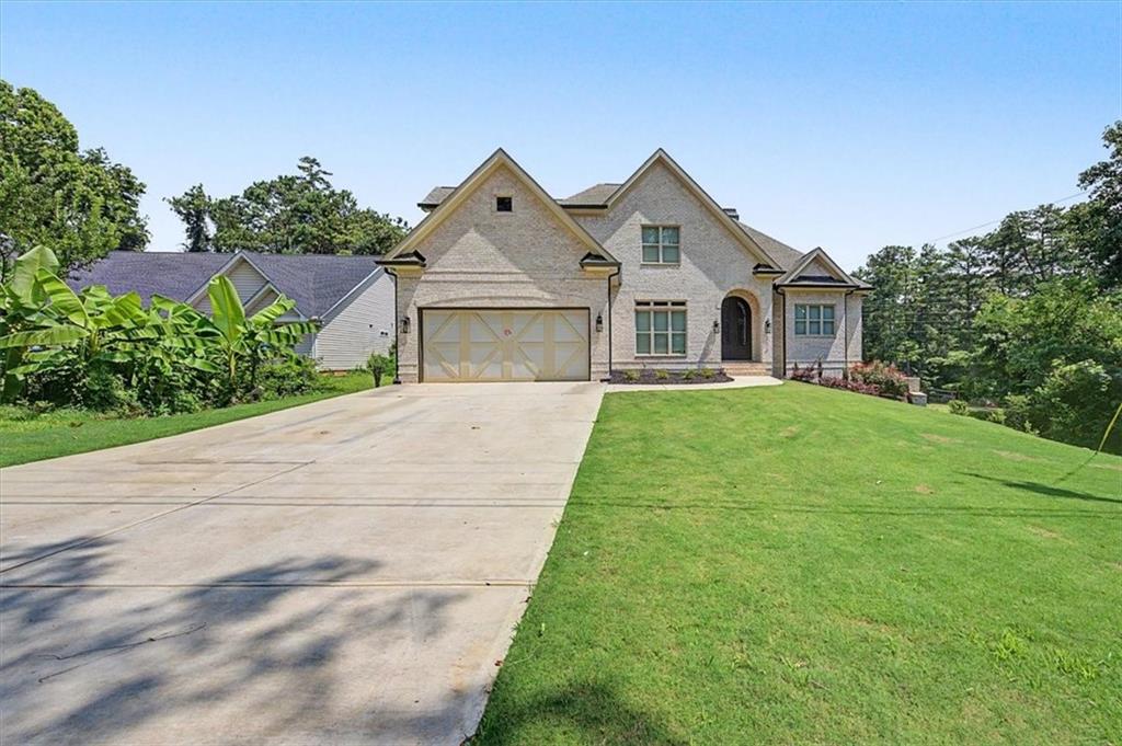 217 Laura Lake Road Marietta, GA 30066 - Photo 2 of 54 a front view of a house with a yard and trees