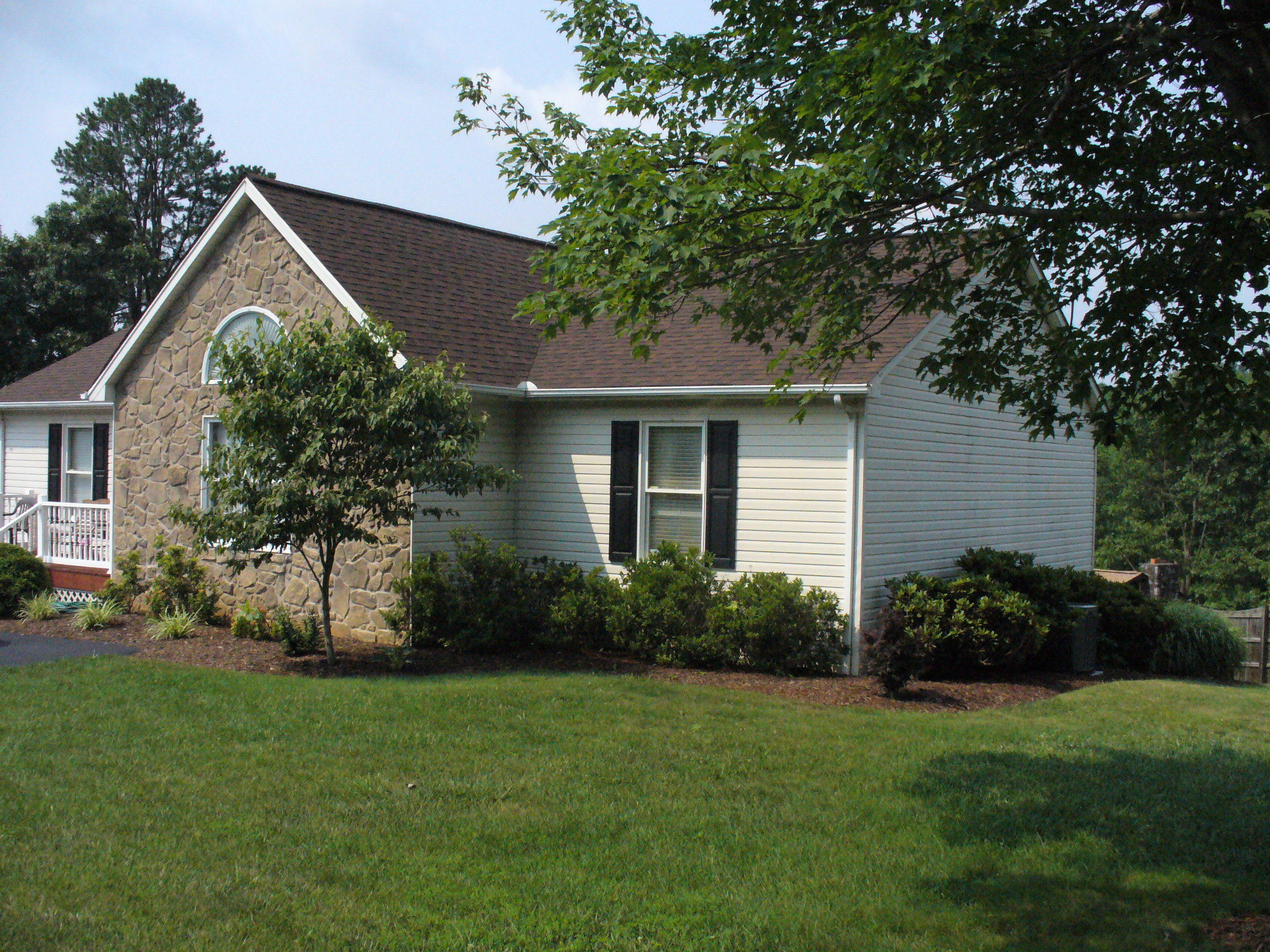 211 Oak Ridge Court Blue Ridge, VA 24064 - Photo 3 of 20 a front view of a house with garden