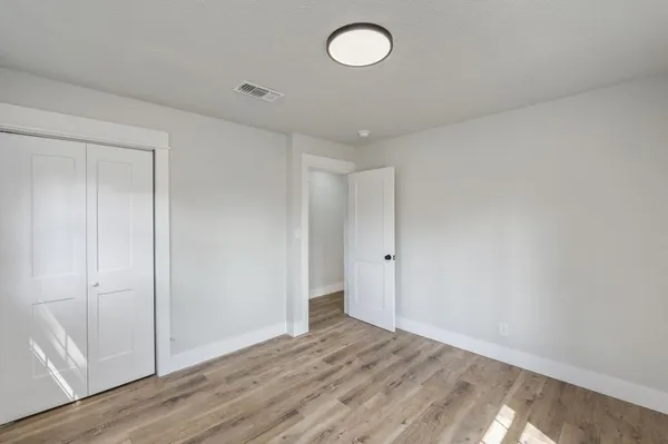 a view of an empty room and wooden floor
