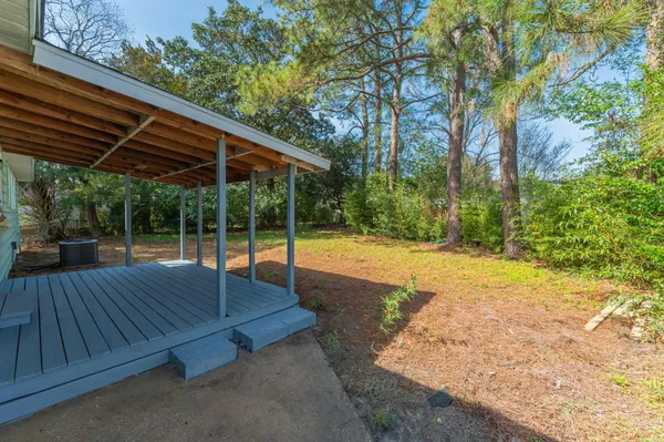 a view of backyard with a patio and wooden fence