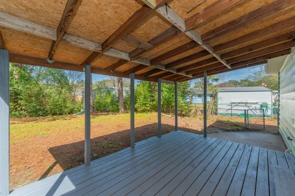 a view of porch with wooden floor