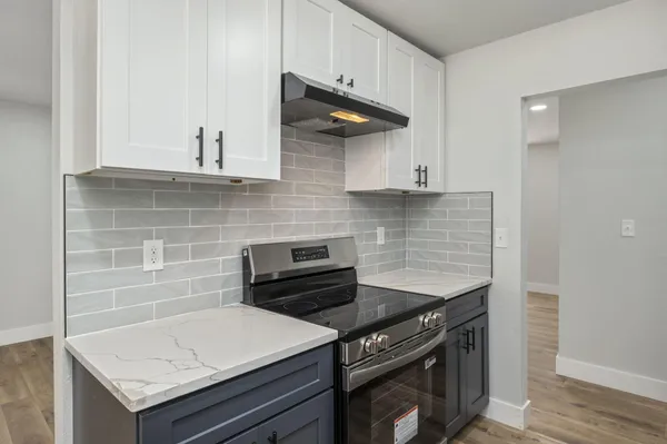 a kitchen with a stove and a microwave