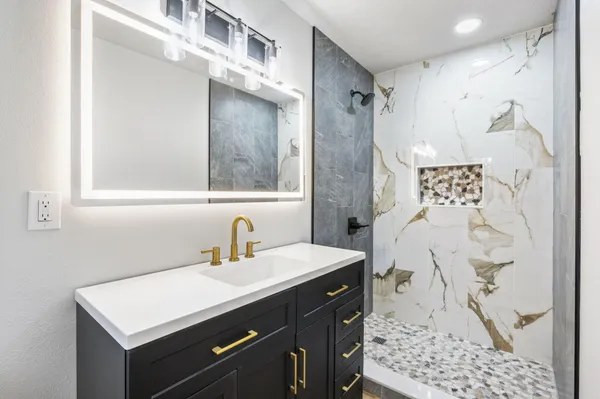 a bathroom with a sink and a mirror
