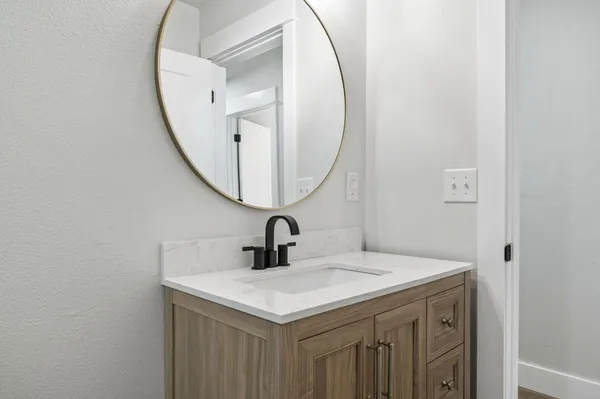a bathroom with a sink and a mirror