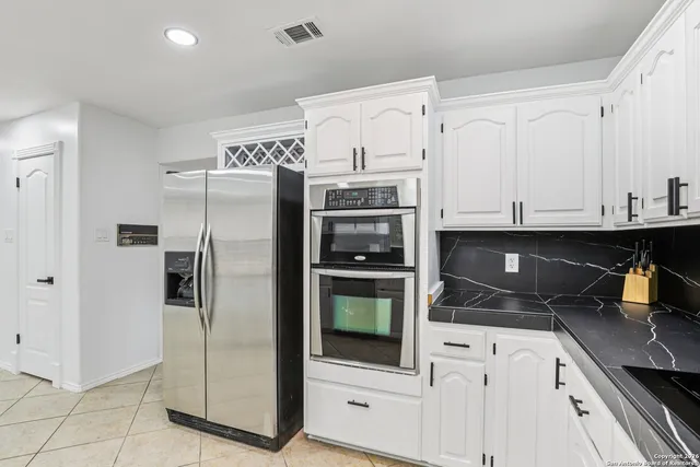 a kitchen with stainless steel appliances a refrigerator sink and cabinets