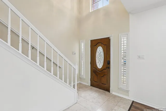 a view of an entryway with wooden floor and door