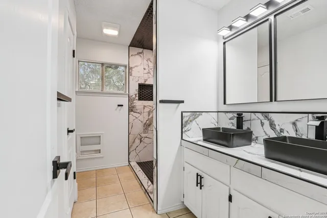 a bathroom with a sink and a mirror
