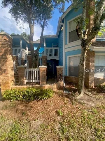 a view of a house with a yard and sitting area