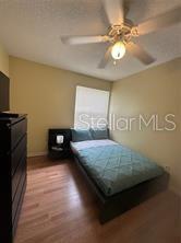 2737 North Poinciana Boulevard, Unit 87 Kissimmee, FL 34746 - Photo 7 of 13 a living room with hard wood floors and a fireplace