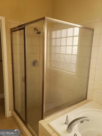 a bathroom with a shower and a sink