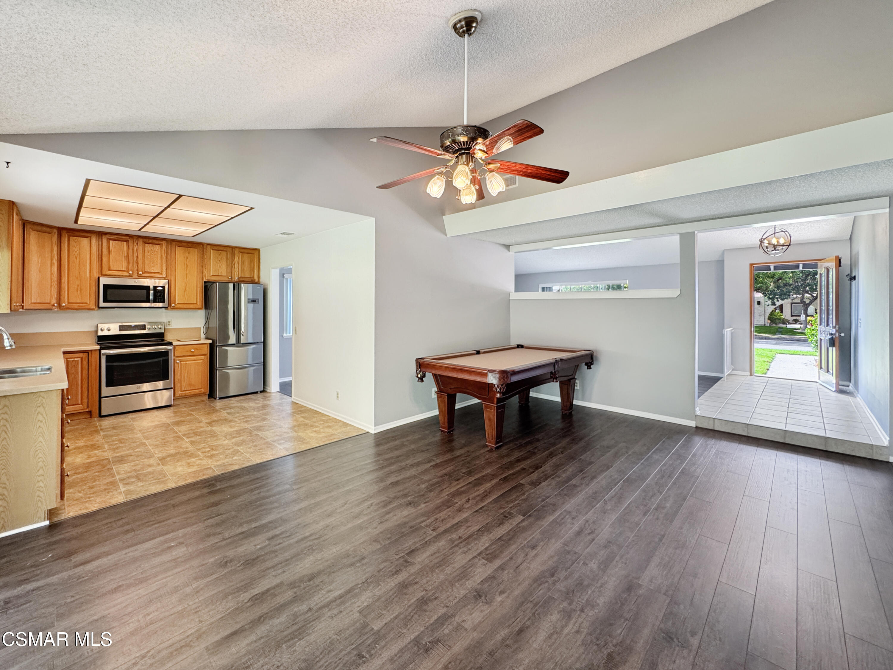 2948 Texas Avenue Simi Valley, CA 93063 - Photo 8 of 32 a view of a room with wooden floor a ceiling fan windows and a kitchen