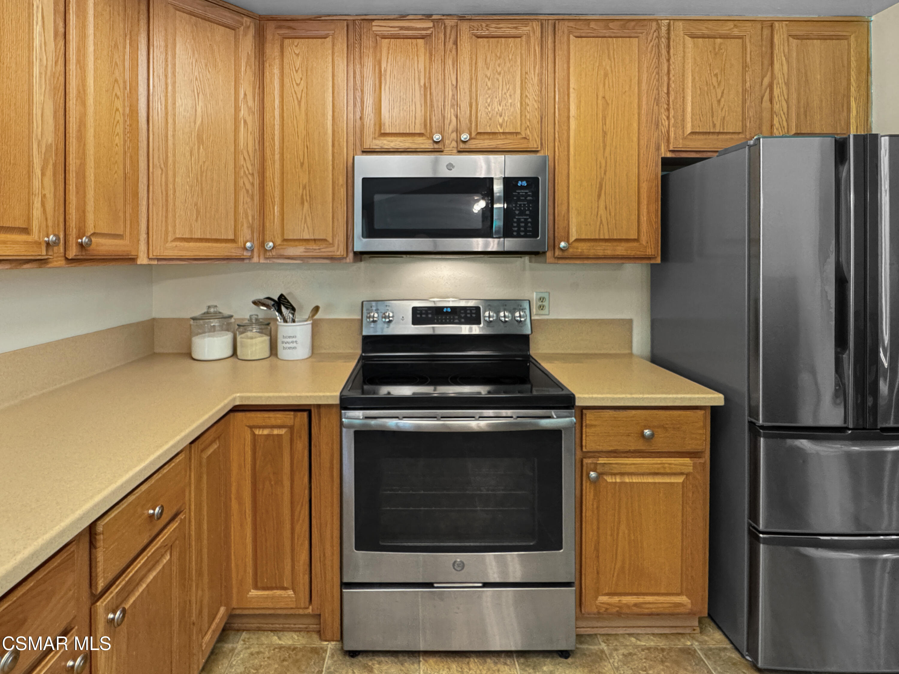 2948 Texas Avenue Simi Valley, CA 93063 - Photo 10 of 32 a kitchen with stainless steel appliances wooden cabinets and a stove