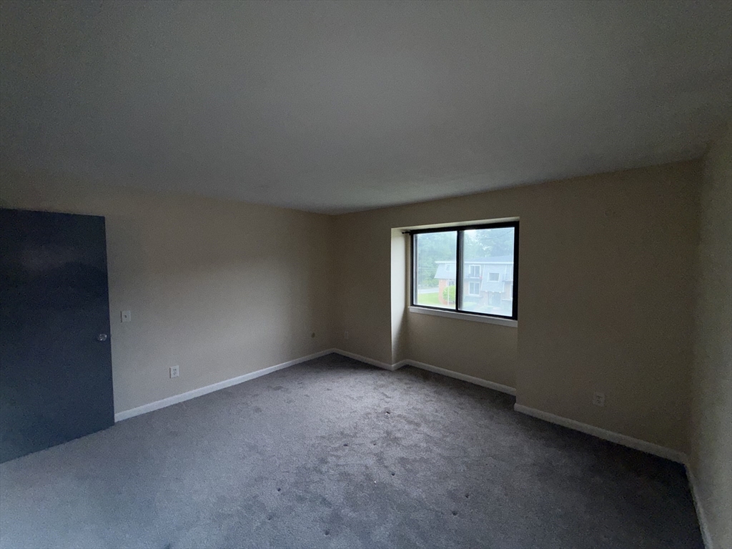 176 Maple Avenue, Unit 131 Rutland, MA 01543 - Photo 8 of 16 an empty room with a window