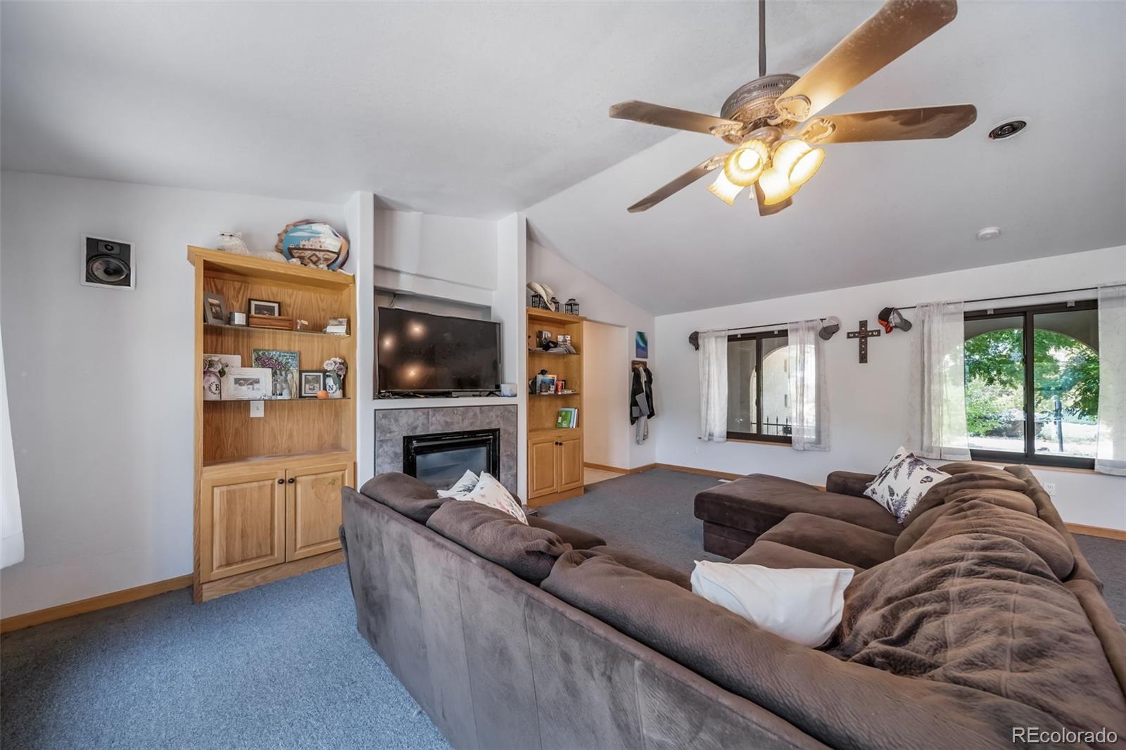 305 Kimble Avenue Swink, CO 81077 - Photo 12 of 44 a living room with furniture and a flat screen tv