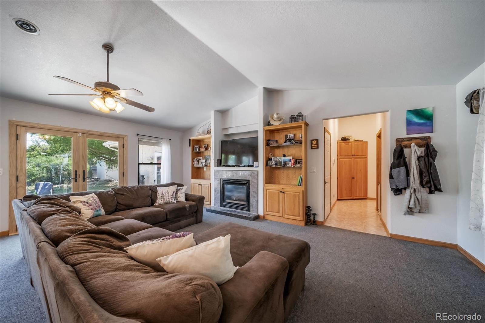 305 Kimble Avenue Swink, CO 81077 - Photo 14 of 44 a living room with furniture and a chandelier