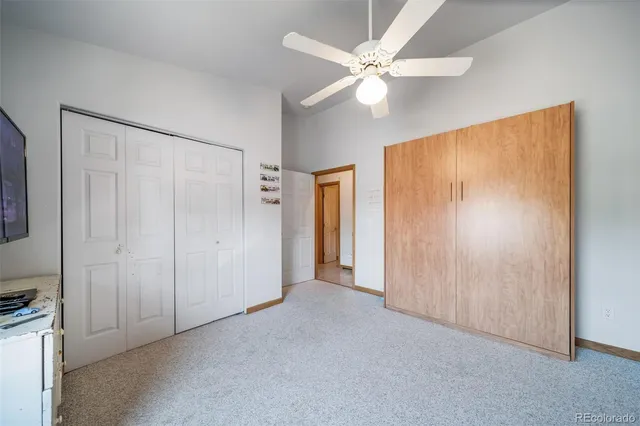 a view of a room with an entryway and fan