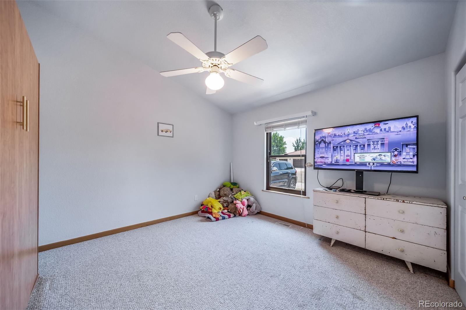 305 Kimble Avenue Swink, CO 81077 - Photo 17 of 44 a living room with furniture and a flat screen tv