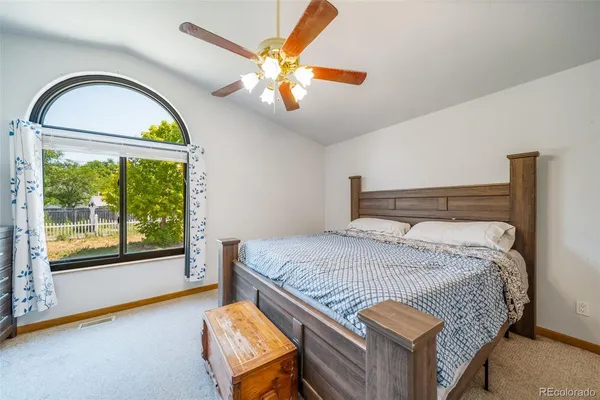 a bedroom with a bed and a large window