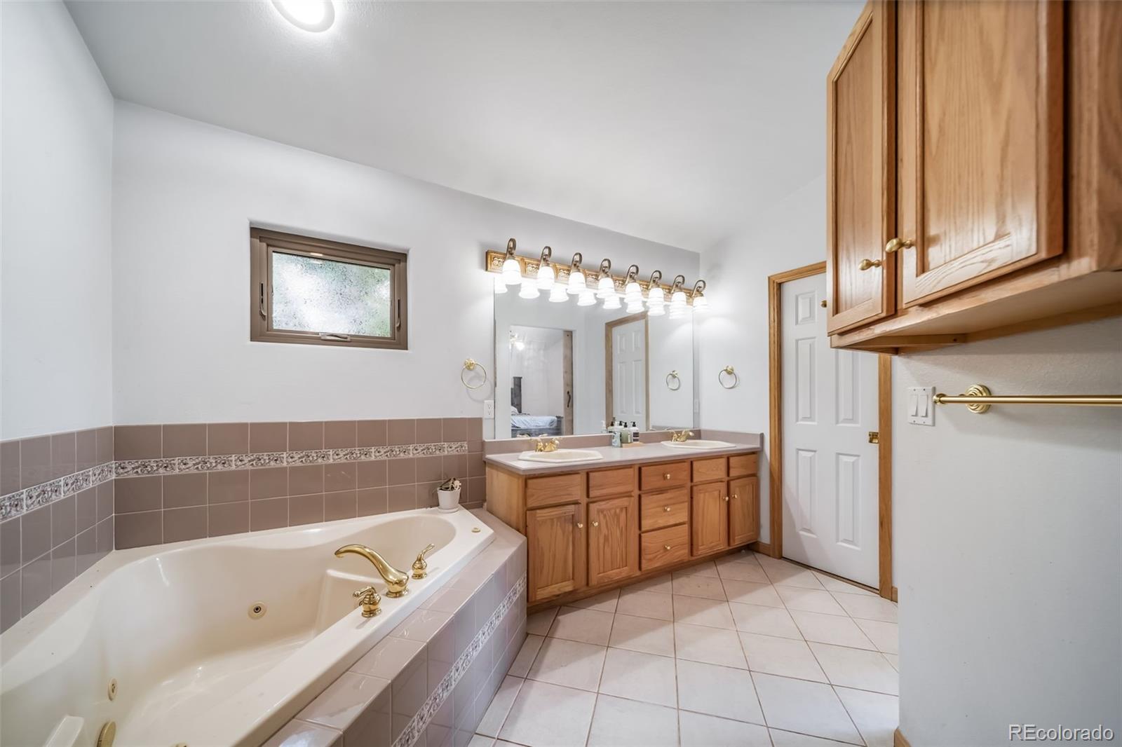 305 Kimble Avenue Swink, CO 81077 - Photo 23 of 44 a bathroom with a tub a sink and a large mirror