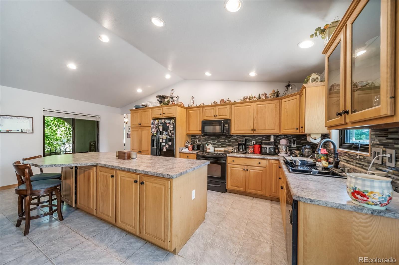 305 Kimble Avenue Swink, CO 81077 - Photo 32 of 44 a kitchen with a sink a counter top space appliances and cabinets