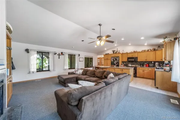 a living room with furniture and kitchen view