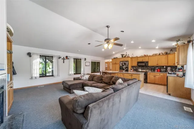 a living room with furniture and kitchen view
