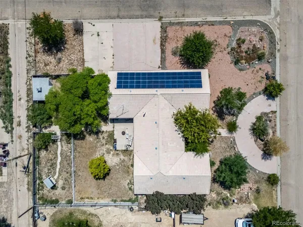 an aerial view of a house with a yard and plants