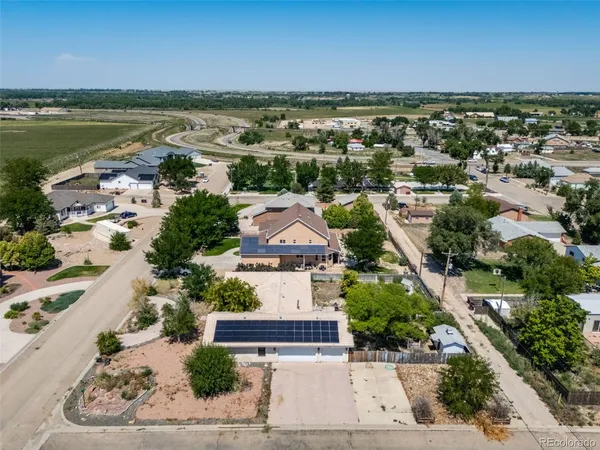 an aerial view of residential houses with outdoor space