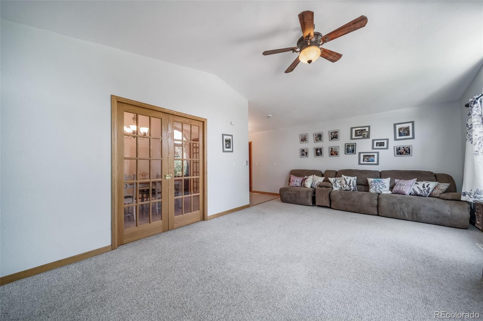 305 Kimble Avenue Swink, CO 81077 - Photo 8 of 44 a living room with furniture and ceiling fan