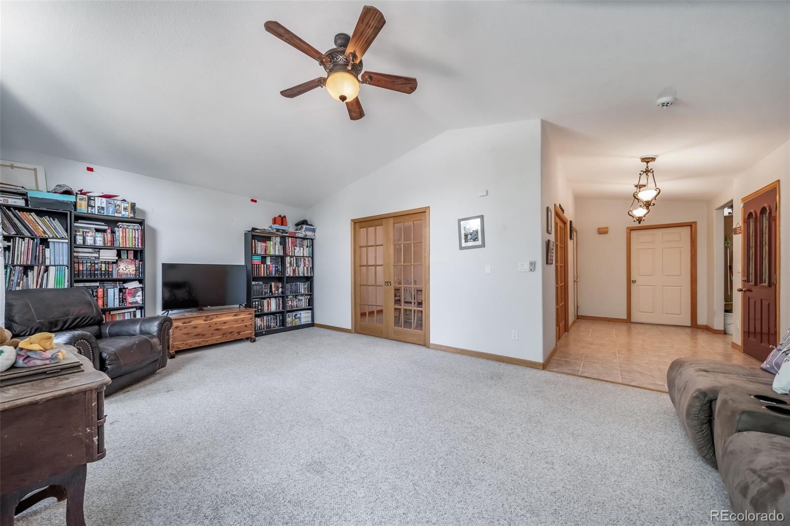 305 Kimble Avenue Swink, CO 81077 - Photo 9 of 44 a view of a livingroom with furniture and a ceiling fan