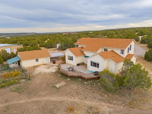an aerial view of a house with a yard and lake view