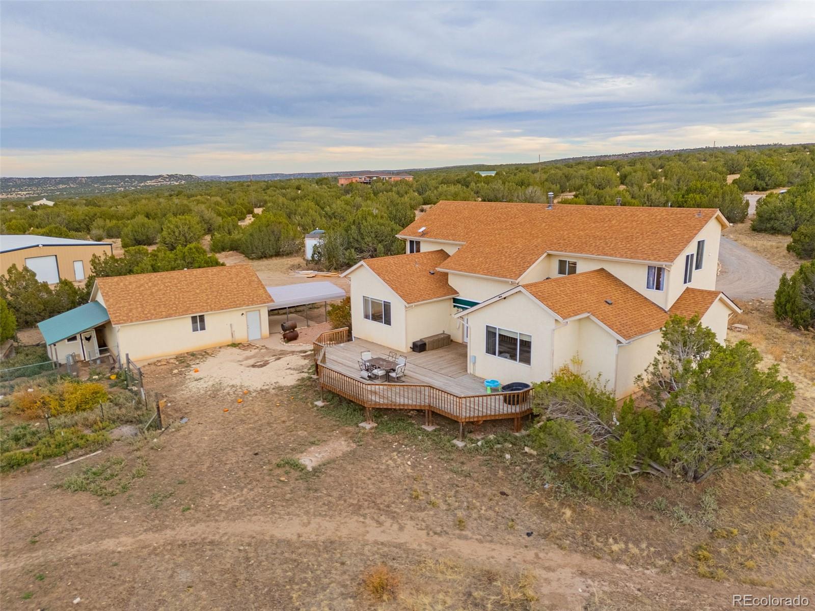 an aerial view of a house with a yard and lake view