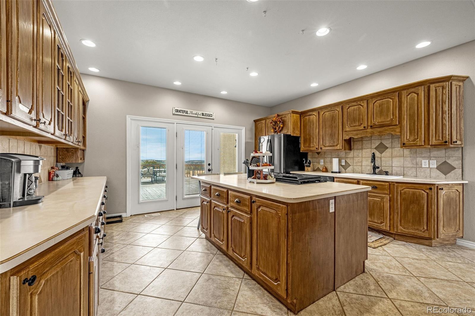 3115 Canyon Heights Road Pueblo, CO 81005 - Photo 12 of 44 a kitchen with stainless steel appliances granite countertop a stove and a sink