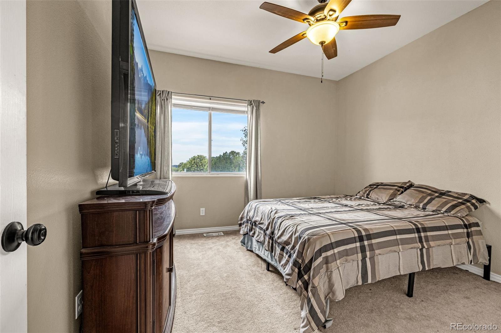 3115 Canyon Heights Road Pueblo, CO 81005 - Photo 17 of 44 a bed sitting in a bedroom next to a window