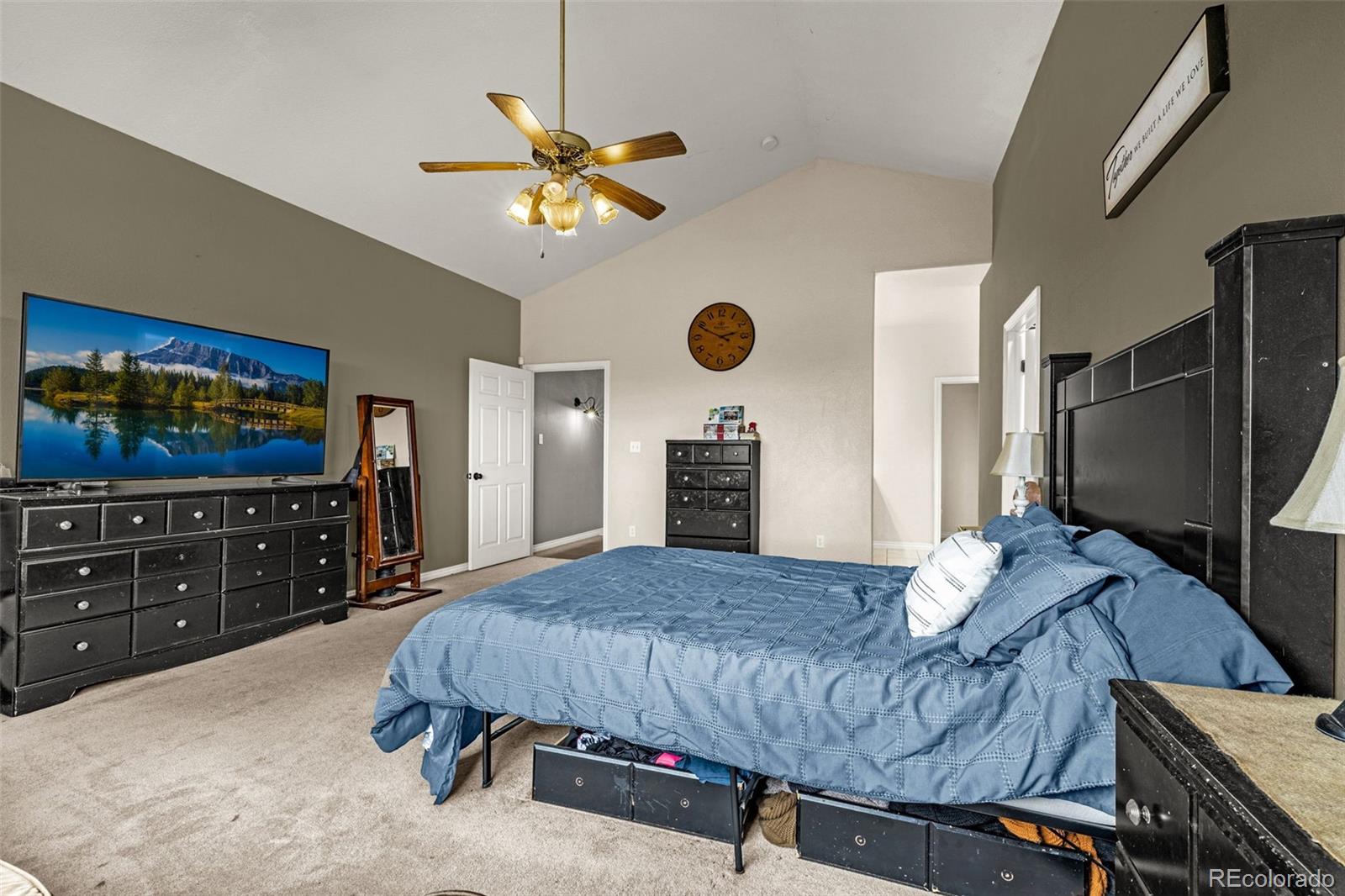 3115 Canyon Heights Road Pueblo, CO 81005 - Photo 20 of 44 a bedroom with a bed and dresser with mirror