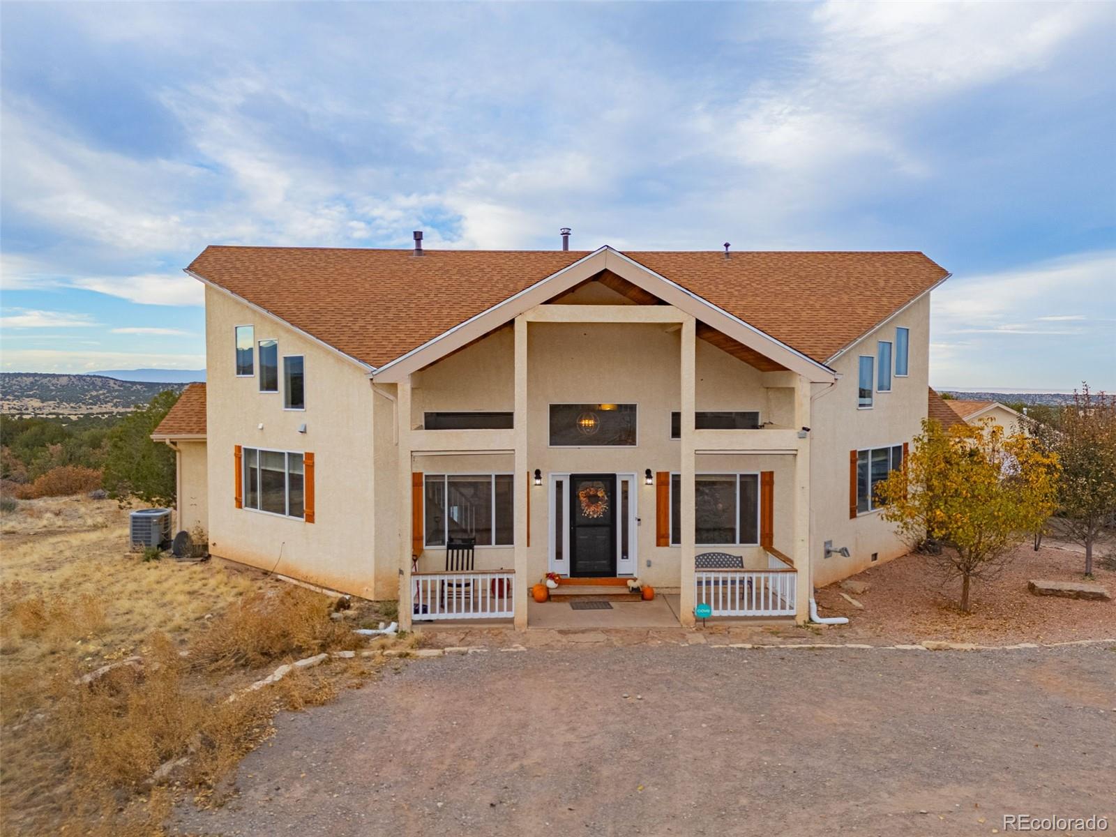 3115 Canyon Heights Road Pueblo, CO 81005 - Photo 2 of 44 a front view of a house with a yard