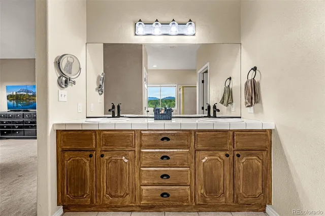 a bathroom with a sink vanity and a mirror