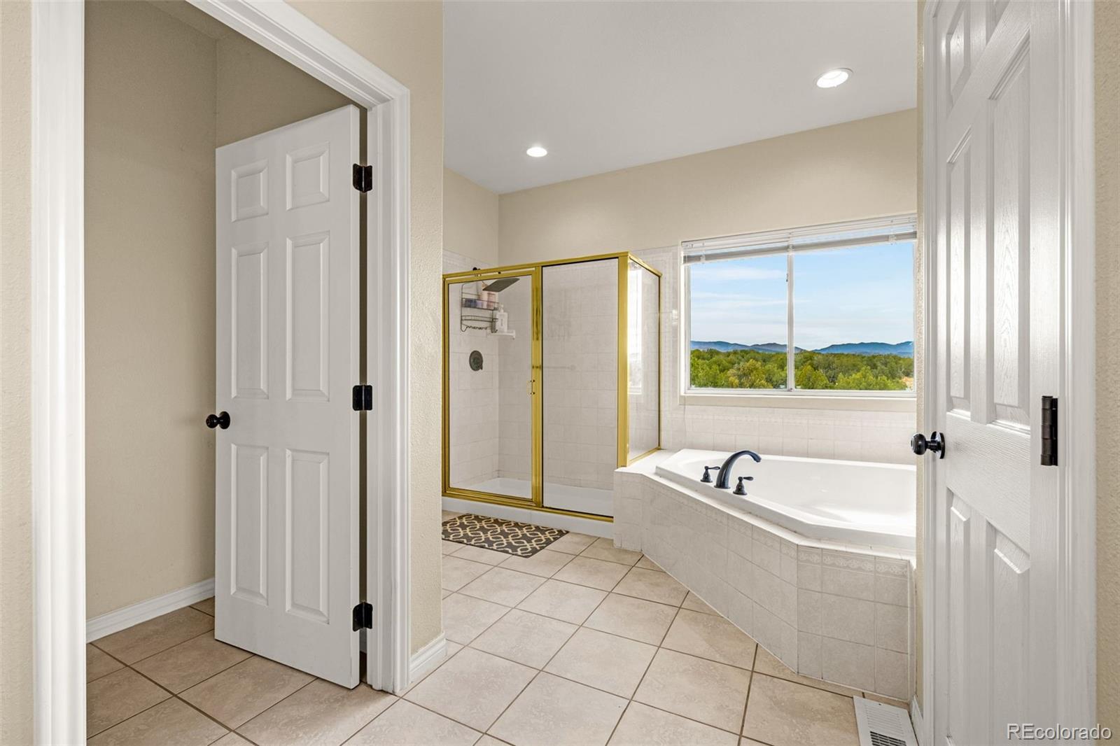 3115 Canyon Heights Road Pueblo, CO 81005 - Photo 30 of 44 a bathroom with a tub a sink and a shower