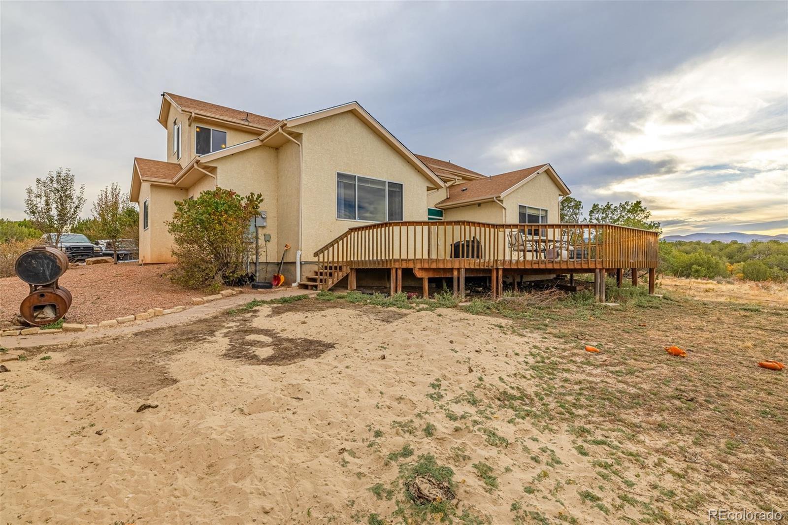 3115 Canyon Heights Road Pueblo, CO 81005 - Photo 37 of 44 a view of a house with a yard and sitting area