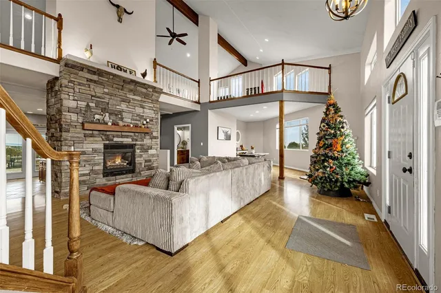 a living room with furniture wooden floor and a fireplace