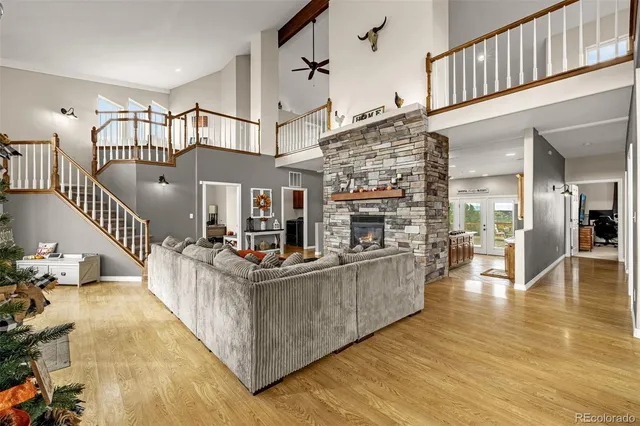 a view of a living room and kitchen with furniture wooden floor and windows