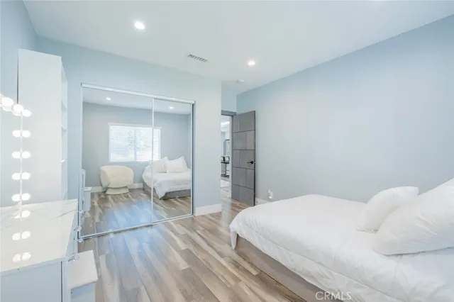 a bedroom with a bed and a mirror