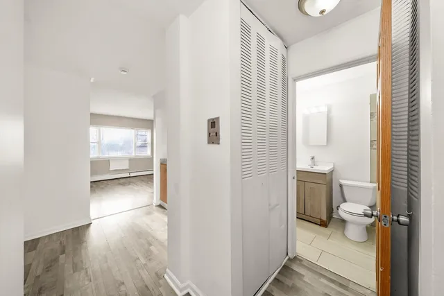 a bathroom with a toilet and a shower
