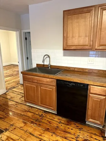 a kitchen with stainless steel appliances granite countertop a sink and a stove top oven