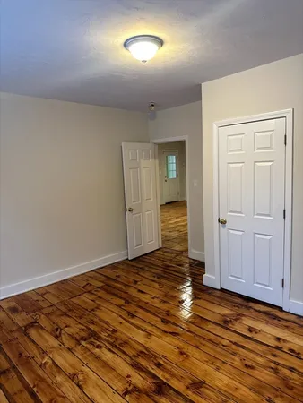 a view of a livingroom with wooden floor and closet area